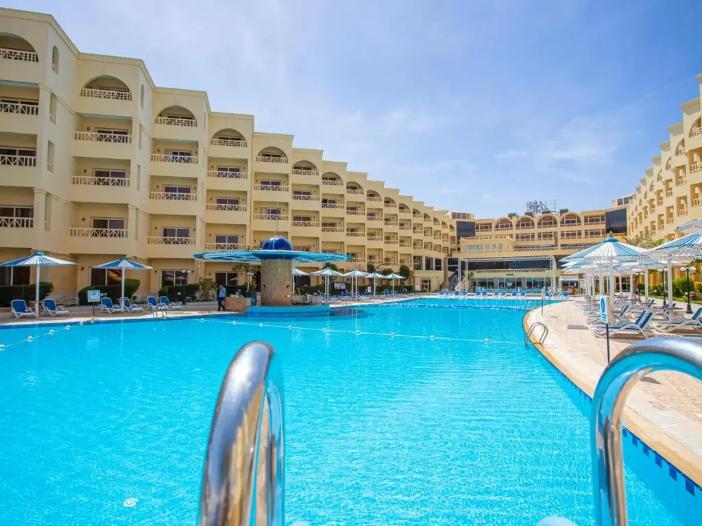 Големият басейн със стълба пред сградите с арки – AMC Royal Hotel & Spa, Хургада