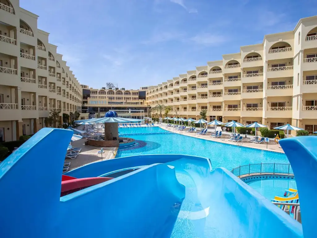 Сини пързалки над дългия басейн между крилата на хотела – AMC Royal Hotel & Spa, Хургада