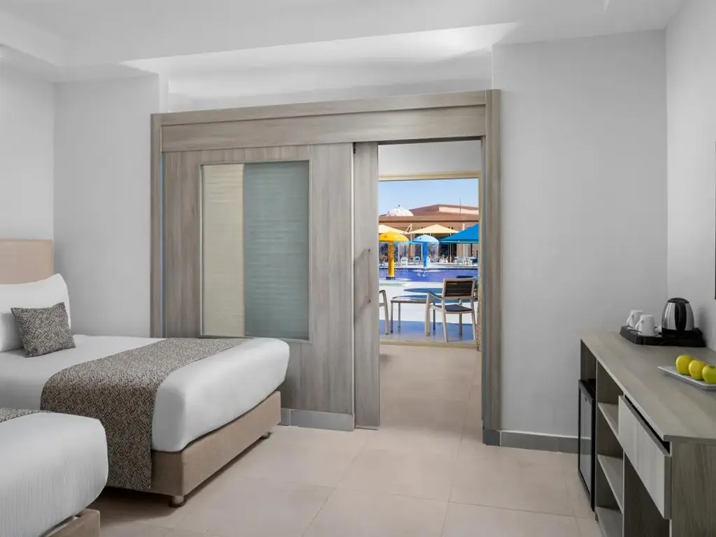 Две легла и плъзгаща врата с изглед към басейн – Pickalbatros Jungle Aqua Park Resort - Neverland Hurghada, Хургада